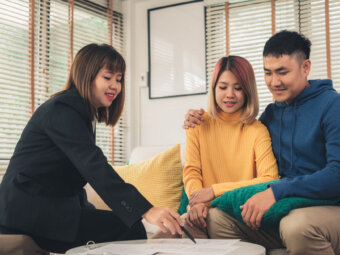 Financial expert assisting a couple with personal loan options and flexible terms in Toronto
