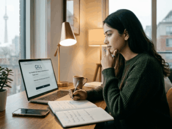 A young woman sitting at a desk in a Toronto apartment, thoughtfully reviewing a personal loan application on her laptop as she follows the 